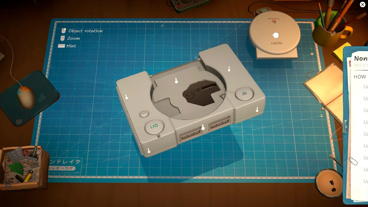 Game console on the repair mat with screw locations highlighted for disassembly