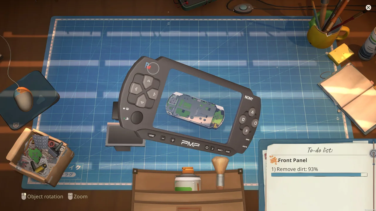 Partially disassembled handheld device on the ReStory repair workbench